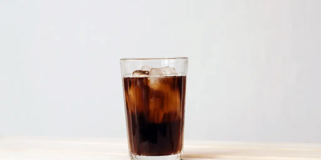 Iced coffee without milk in a clear glass with several icecubes