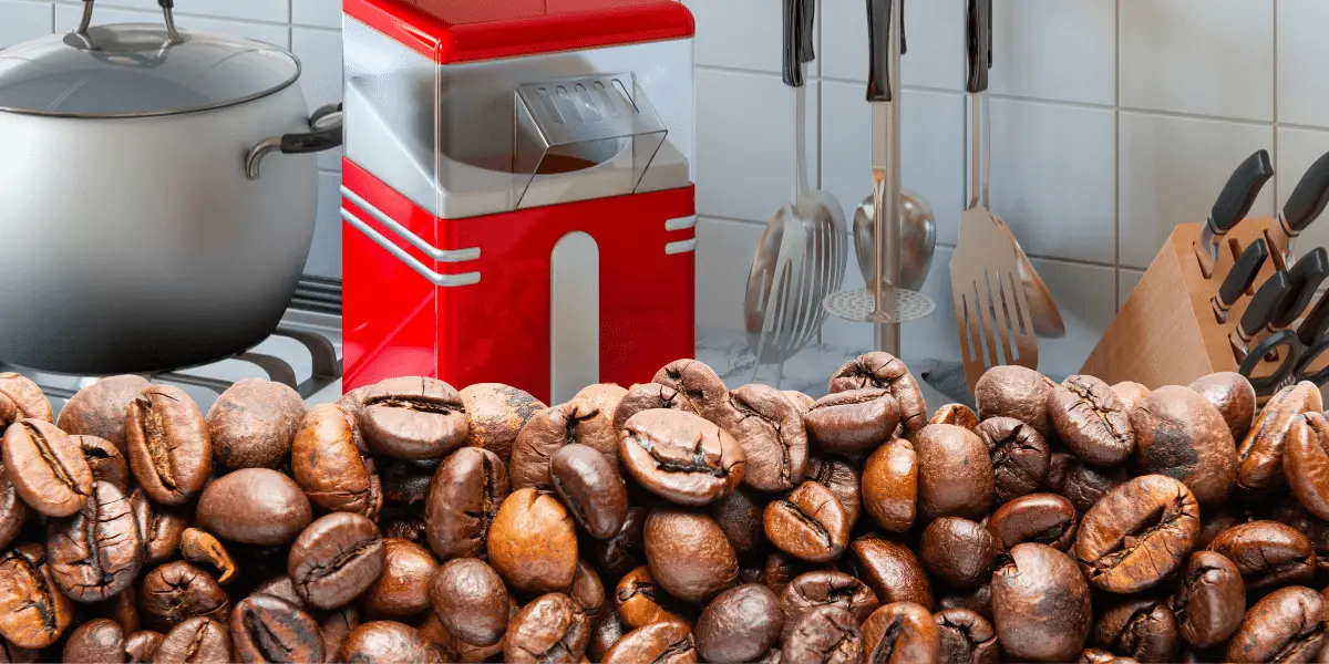 Popcorn maker in the background with a large amount of coffee beans in the foreground.
