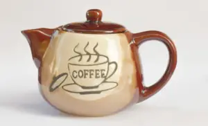 Teapot with an imprint of a coffee cup and the word coffee.