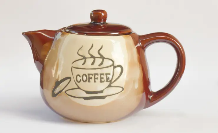 Teapot with an imprint of a coffee cup and the word coffee.