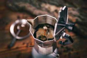 A top down view of a Moka pot filled with the top open showing freshly brewed coffee.