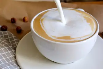 Milk being poured into a cup of coffee after it was found to be way too sweet.
