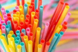 A large bunch of different colored small coffee drinking straws.