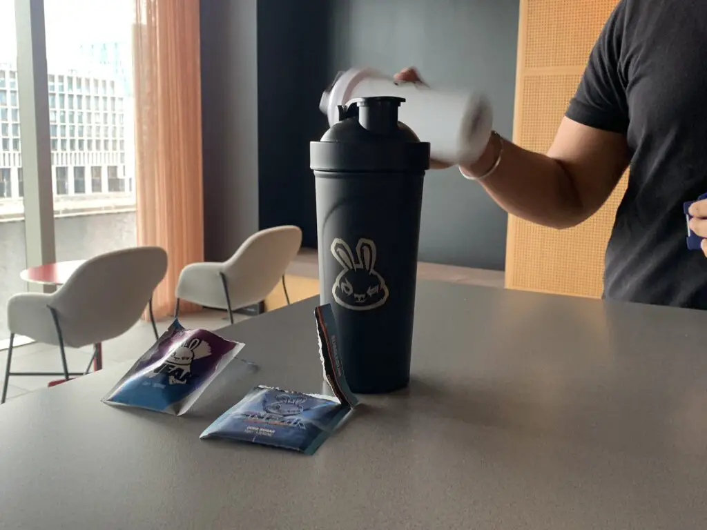 Shaking the Sneak Energy shaker to mix the sachets.