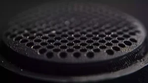 A macro close-up of a sticky Aeropress plunger gasket, highlighting the intricate details and texture. The focus is on the stickiness and the gasket's material, creating a tactile and realistic representation.
